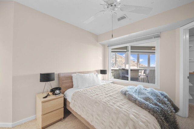 bedroom featuring ceiling fan and light carpet