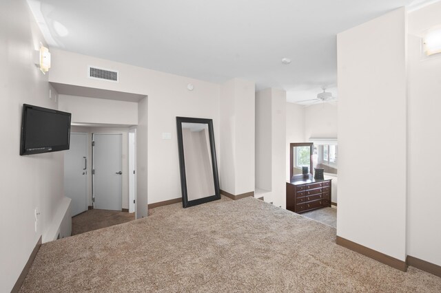 unfurnished bedroom featuring light carpet