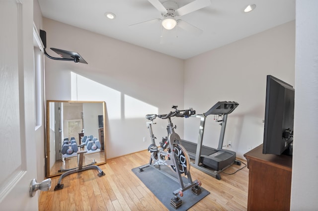 workout area with light hardwood / wood-style flooring and ceiling fan