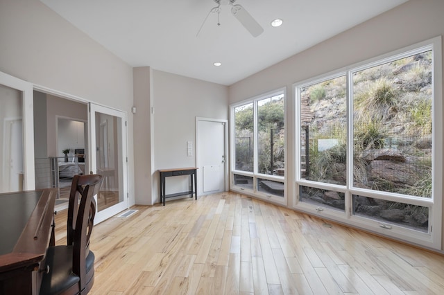 interior space with ceiling fan