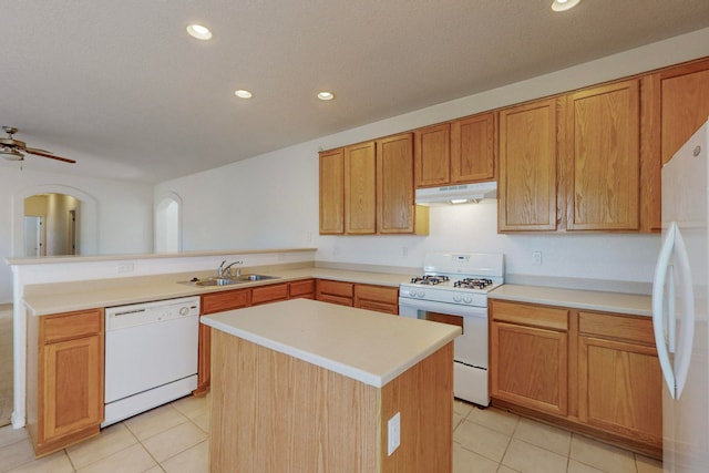 kitchen with a kitchen island, sink, light tile patterned floors, white appliances, and ceiling fan