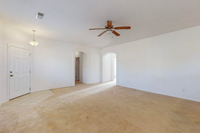 spare room featuring ceiling fan and light colored carpet