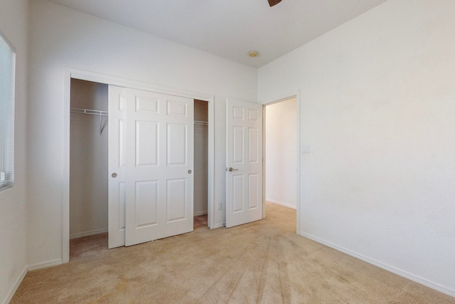 unfurnished bedroom with a closet and light carpet