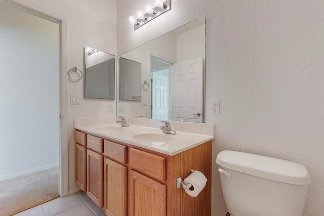 bathroom with vanity, toilet, and tile patterned flooring