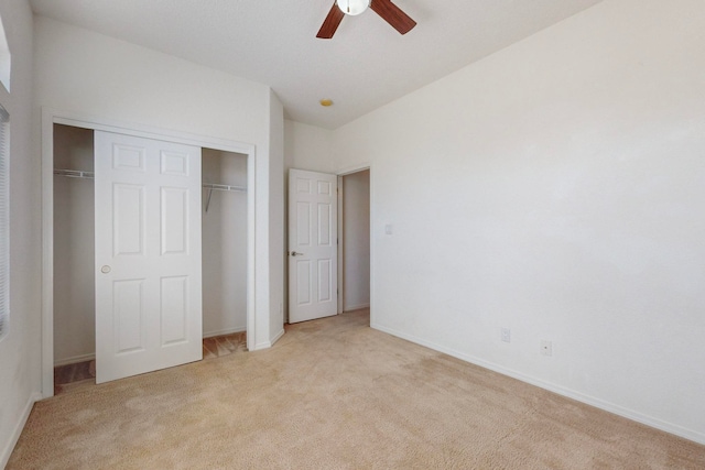 unfurnished bedroom featuring a closet, ceiling fan, and light carpet