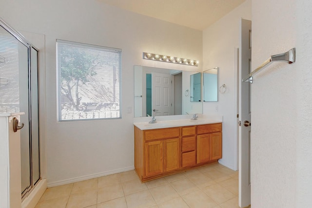 bathroom with vanity, walk in shower, and tile patterned flooring