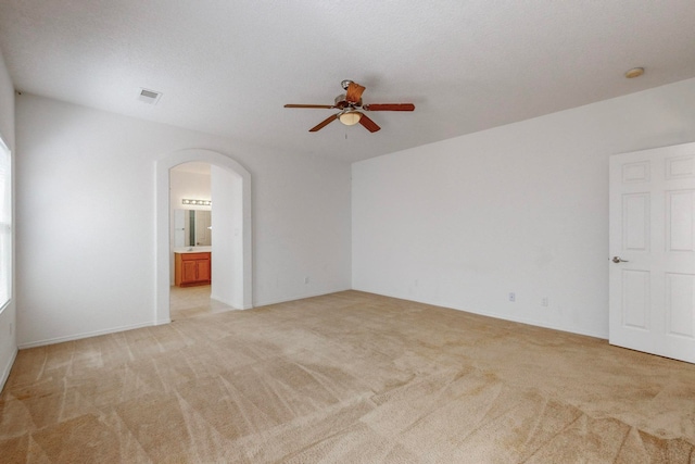 carpeted spare room with a textured ceiling and ceiling fan