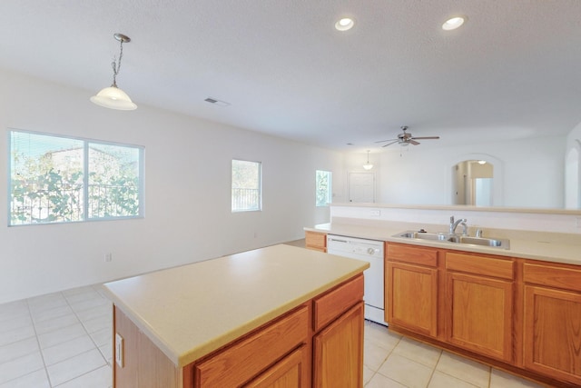 kitchen with sink, light tile patterned flooring, white dishwasher, a center island, and decorative light fixtures