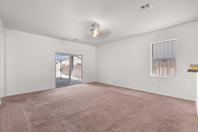 spare room featuring carpet flooring and ceiling fan