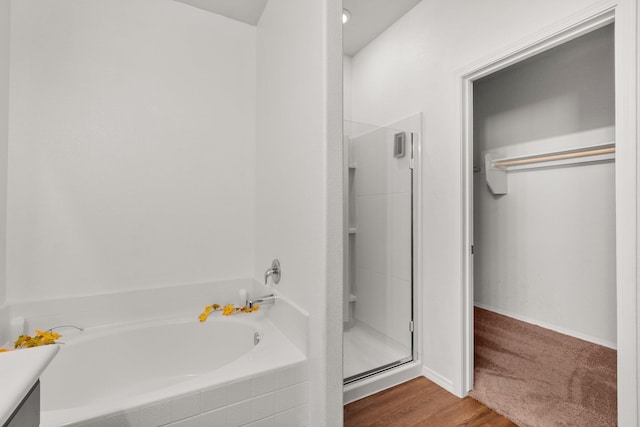 bathroom featuring vanity, independent shower and bath, and wood-type flooring