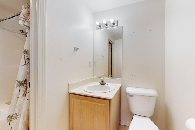 bathroom featuring vanity, a shower with shower curtain, and toilet