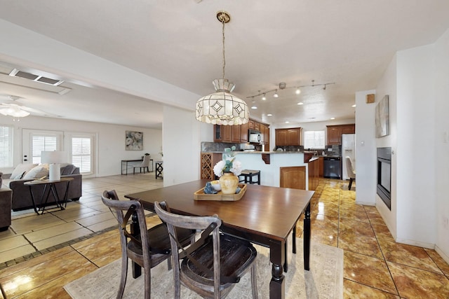 dining space featuring ceiling fan and light tile patterned floors