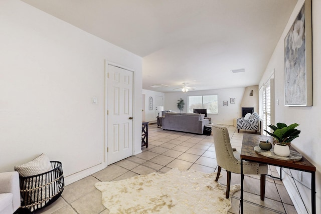 tiled dining space with ceiling fan