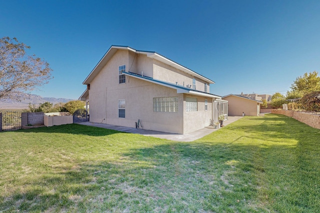 rear view of house featuring a lawn and a mountain view