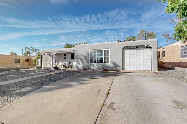 pueblo-style house with a garage