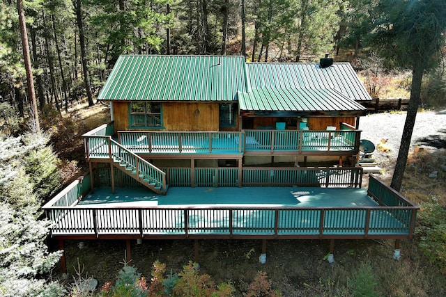 rear view of house featuring a deck