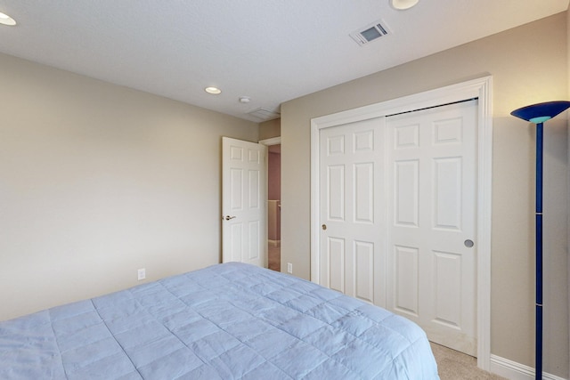 carpeted bedroom featuring a closet