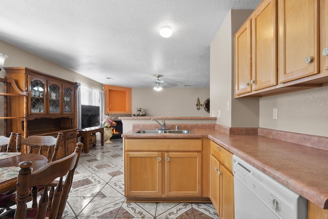 kitchen with a textured ceiling, sink, dishwasher, kitchen peninsula, and ceiling fan