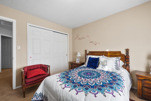 carpeted bedroom with a closet and a textured ceiling