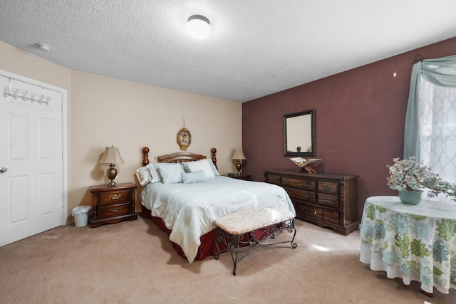 bedroom featuring a textured ceiling and light carpet