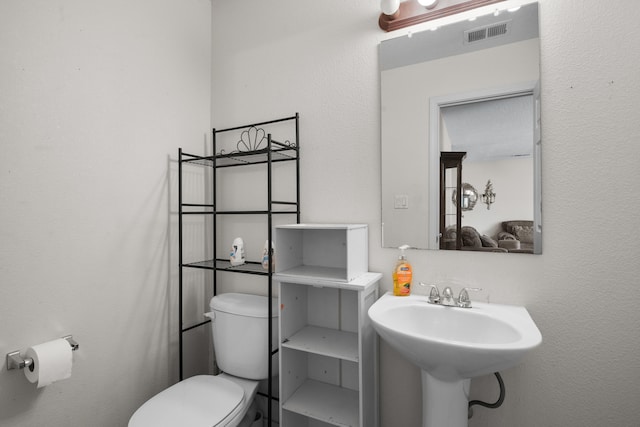 bathroom featuring sink and toilet