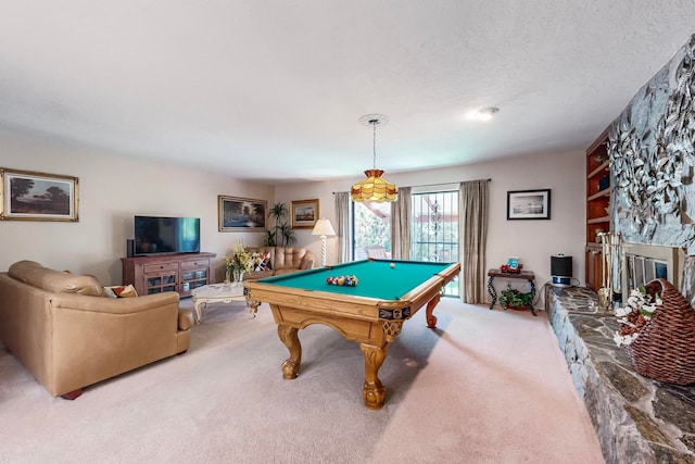 rec room featuring a fireplace, a textured ceiling, built in features, light carpet, and billiards