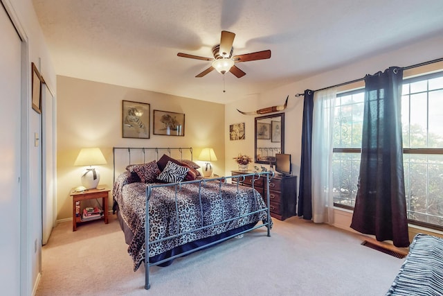 bedroom featuring ceiling fan, carpet, and a textured ceiling