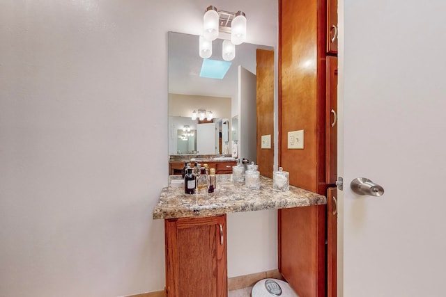 bathroom featuring vanity and a skylight