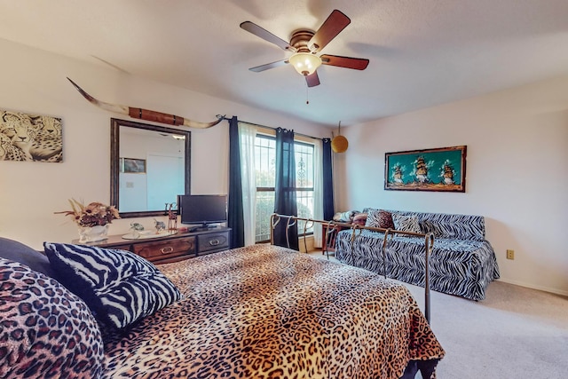 carpeted bedroom featuring ceiling fan