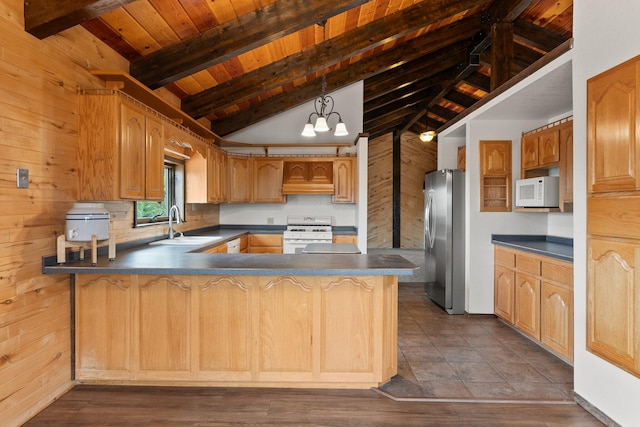 kitchen with dark hardwood / wood-style flooring, wood walls, sink, lofted ceiling with beams, and white appliances