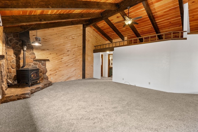 unfurnished living room with wood ceiling, a wood stove, carpet, high vaulted ceiling, and beamed ceiling