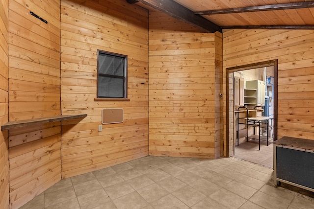 tiled empty room with lofted ceiling with beams, wood walls, and wood ceiling