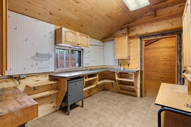 kitchen featuring light brown cabinets, wood ceiling, wooden walls, and vaulted ceiling