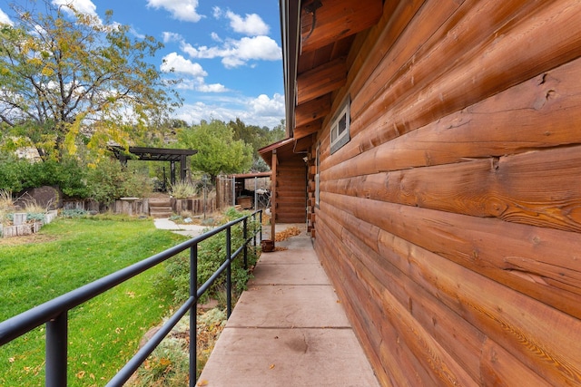 view of side of property with a yard and a pergola