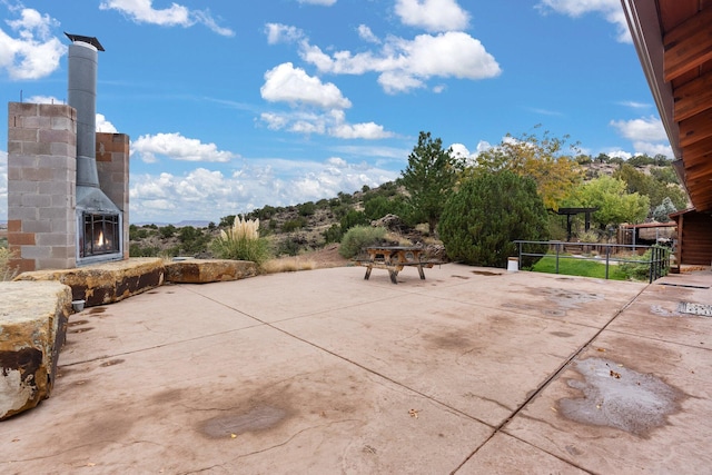 view of patio / terrace with an outdoor fireplace