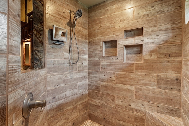 bathroom featuring walk in shower and wooden walls