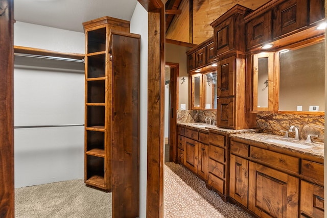 bathroom with decorative backsplash and vanity