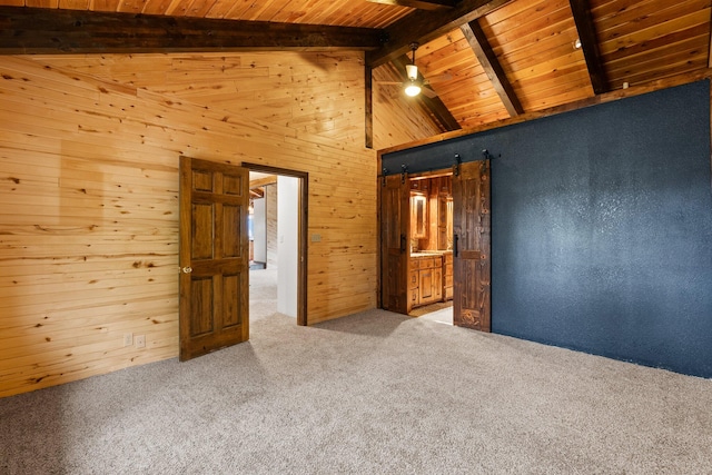 carpeted spare room with wooden ceiling, wood walls, beamed ceiling, ceiling fan, and high vaulted ceiling