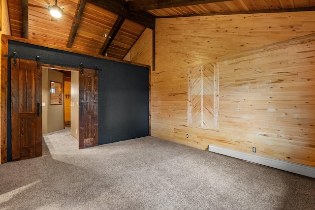 carpeted spare room with a barn door, wooden ceiling, beam ceiling, and wooden walls