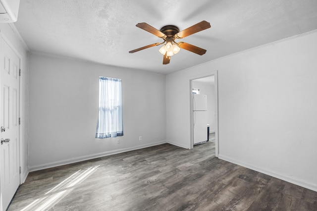 empty room featuring a wall unit AC, dark hardwood / wood-style floors, ornamental molding, a textured ceiling, and ceiling fan