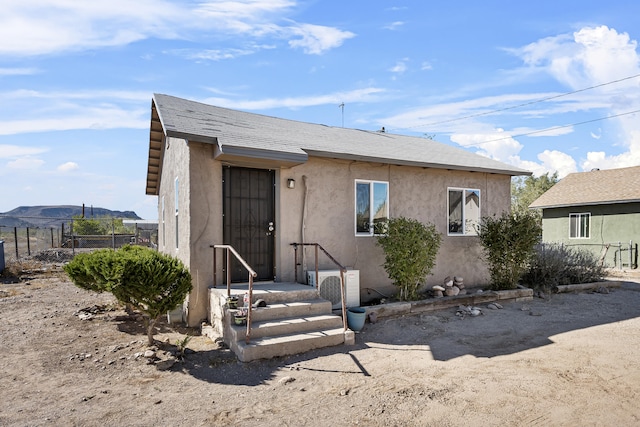 view of front of house featuring ac unit and a mountain view