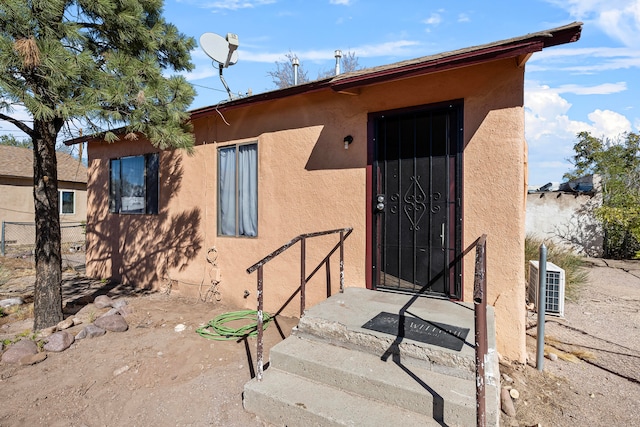 entrance to property featuring central AC unit