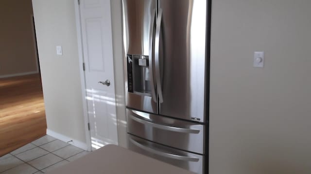 details with light wood-type flooring and stainless steel refrigerator with ice dispenser