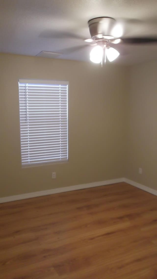 empty room featuring hardwood / wood-style floors and ceiling fan