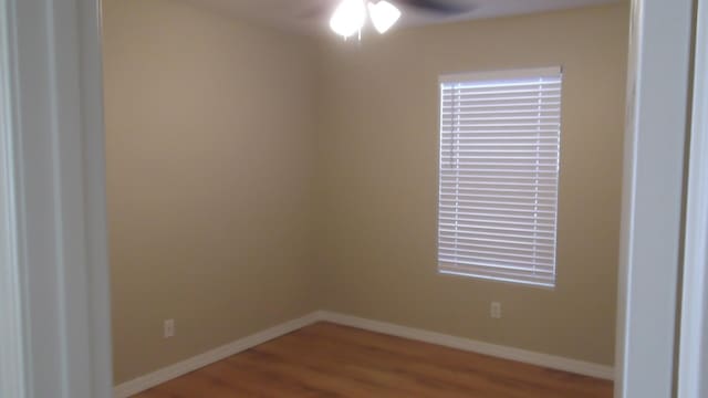 unfurnished room with wood-type flooring and ceiling fan