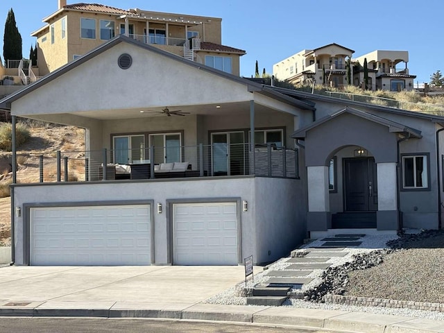 view of front of house featuring a balcony, a garage, and ceiling fan