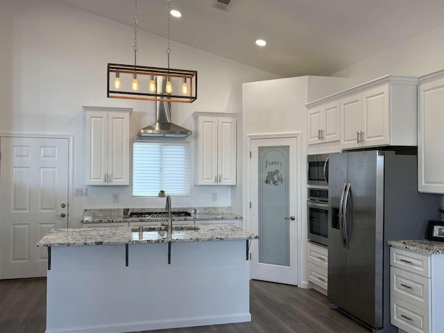 kitchen featuring light stone countertops, stainless steel appliances, vaulted ceiling, and white cabinetry