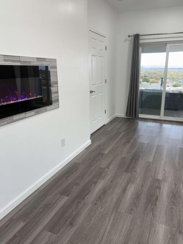 unfurnished living room featuring dark wood-type flooring