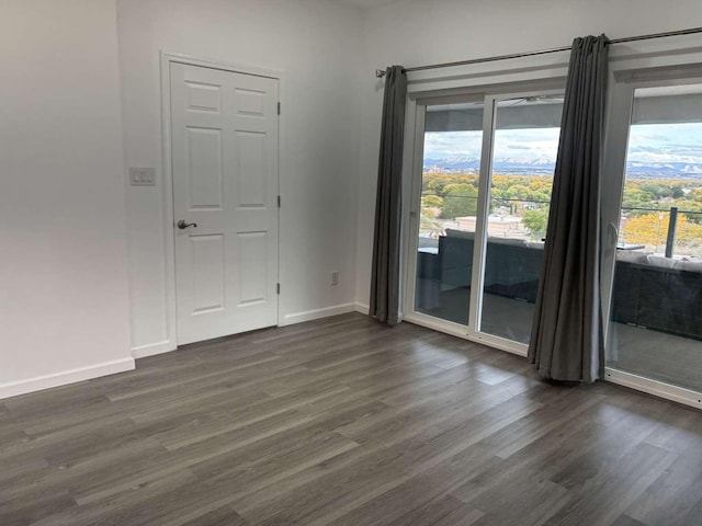 spare room featuring dark hardwood / wood-style floors