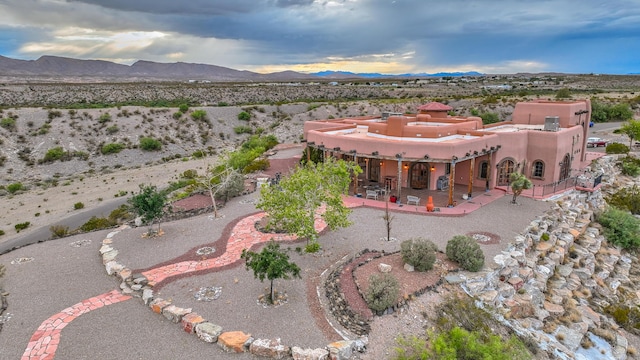 drone / aerial view featuring a mountain view and view of desert